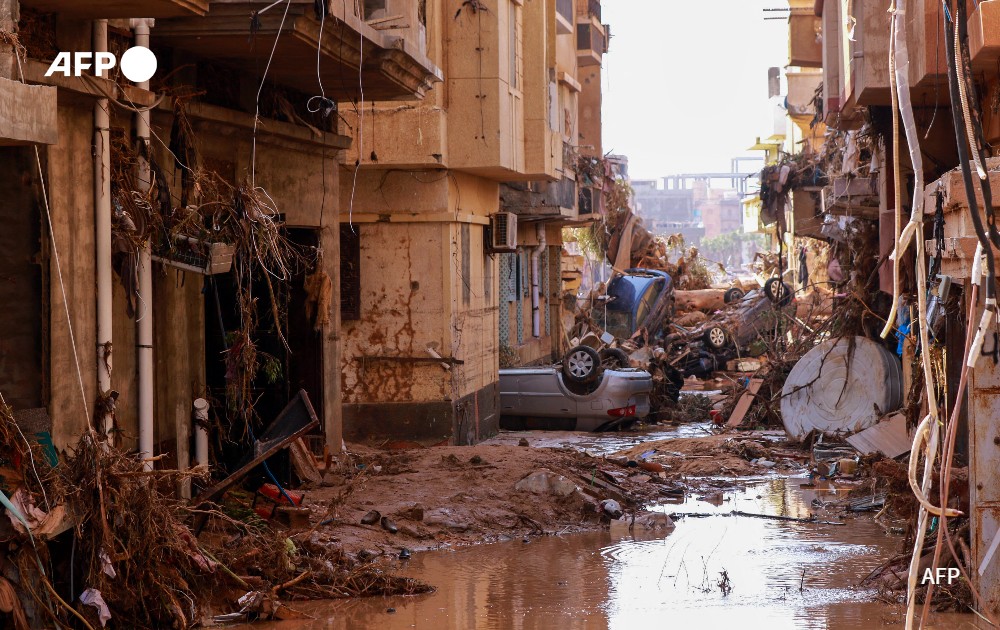 Overturned cars lay among other debris caused by flash floods